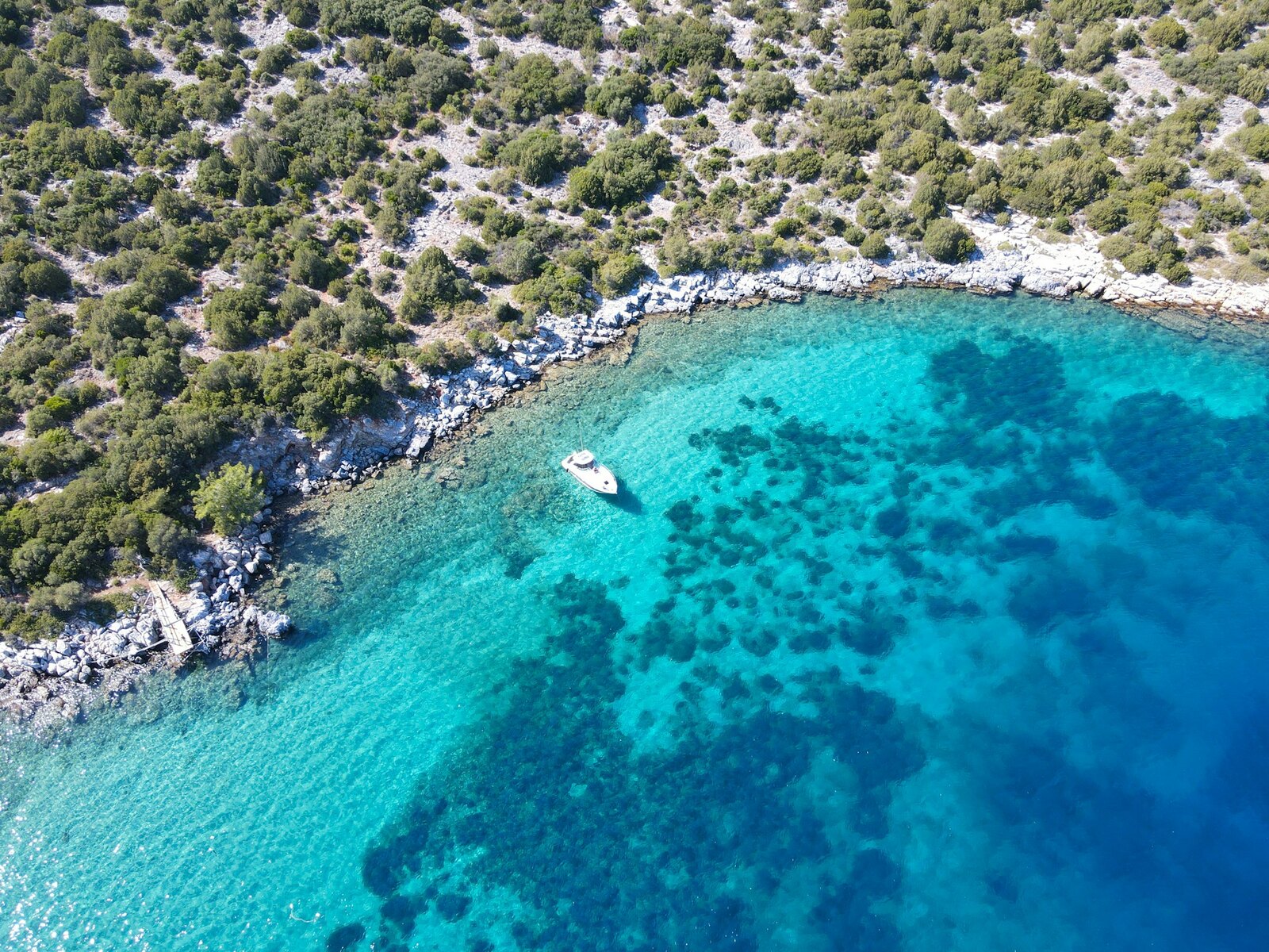 A small motor boat on the turquoise sea near Pefkochori