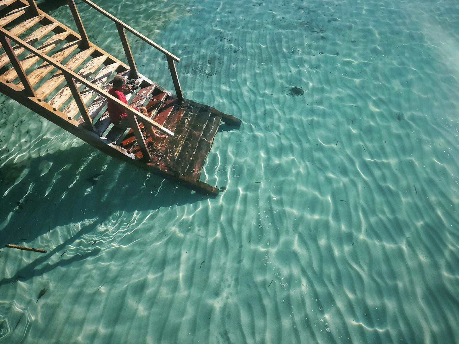 Clear turquoise water beside a moored boat